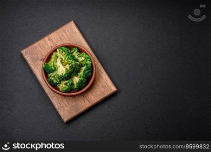 Delicious fresh green broccoli steamed in a ceramic plate on a textured concrete background