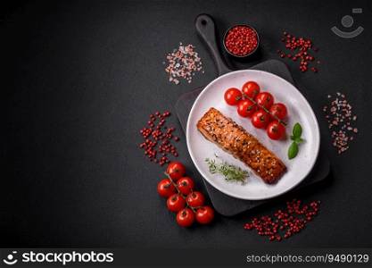 Delicious fresh gril≤d red fish with sa<, sπces and herbs on a dark concrete background