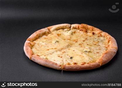 Delicious fresh hot pizza four cheeses on a black concrete background