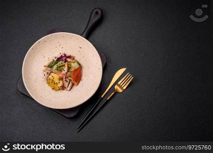 Delicious fresh juicy salad of sliced chicken, grapefruit, lettuce, sesame with olive oil on a ceramic plate on a concrete background
