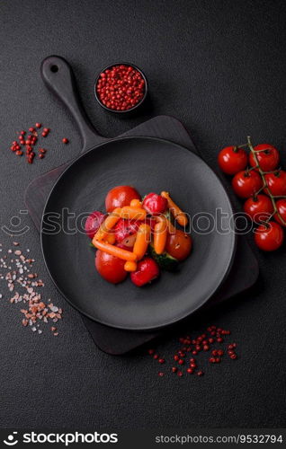 Delicious fresh juicy salad with radishes, tomatoes, carrots, cucumber, spices and herbs on a dark concrete background