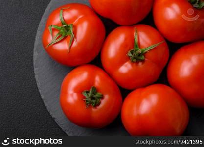 Delicious fresh juicy tomatoes on a dark concrete background. Sauce Ingredients