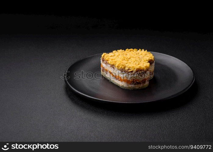 Delicious fresh mimosa salad with canned fish, egg, moinese, cheese, salt and spices on a dark concrete background