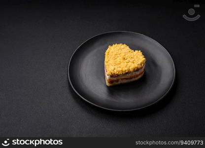 Delicious fresh mimosa salad with canned fish, egg, moinese, cheese, salt and spices on a dark concrete background