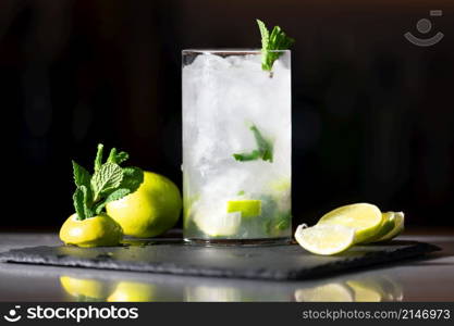 Delicious Fresh Mojito cocktail with ice, lime and mint, close-up, dolly shot. High quality photography. . Delicious Fresh Mojito cocktail with ice, lime and mint, close-up, dolly shot. High quality photography