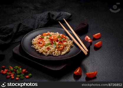 Delicious fresh noodles with sweet pepper, tomato, spices and herbs. Asian cuisine. Delicious fresh noodles with sweet pepper, tomato, spices and herbs