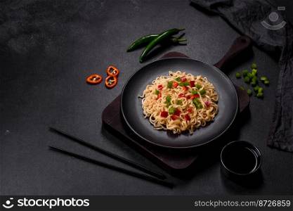 Delicious fresh noodles with sweet pepper, tomato, spices and herbs. Asian cuisine. Delicious fresh noodles with sweet pepper, tomato, spices and herbs