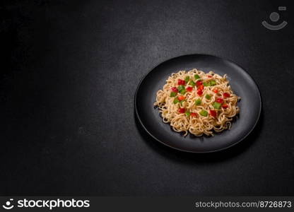 Delicious fresh noodles with sweet pepper, tomato, spices and herbs. Asian cuisine. Delicious fresh noodles with sweet pepper, tomato, spices and herbs