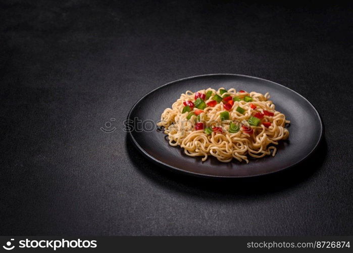 Delicious fresh noodles with sweet pepper, tomato, spices and herbs. Asian cuisine. Delicious fresh noodles with sweet pepper, tomato, spices and herbs