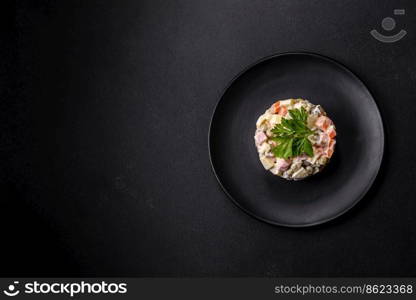 Delicious fresh Olivier salad with sausage, egg, cucumber, green peas, carrots and mayonnaise. Hearty calorie food. Delicious fresh Olivier salad with sausage, egg, cucumber, green peas, carrots and mayonnaise