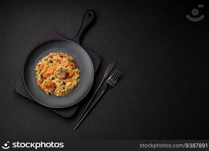 Delicious fresh pilaf with rice, carrots, meat, onions, spices and berries on a ceramic plate on a dark concrete background