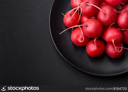 Delicious fresh raw red radish for making healthy salad on dark concrete background