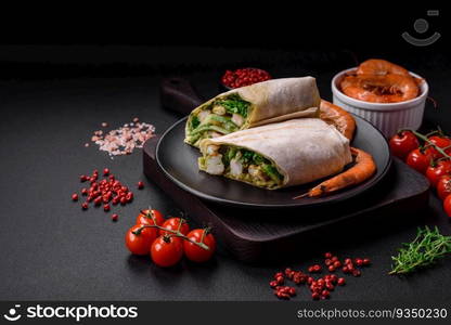 Delicious fresh roll with shrimps, tomatoes, lettuce and cucumber in pita bread on a dark concrete background. Delicious fresh roll with shrimps, tomatoes, lettuce and cucumber in pita bread