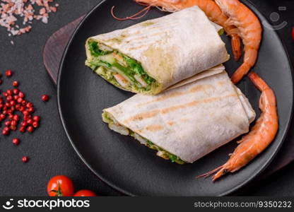 Delicious fresh roll with shrimps, tomatoes, lettuce and cucumber in pita bread on a dark concrete background. Delicious fresh roll with shrimps, tomatoes, lettuce and cucumber in pita bread