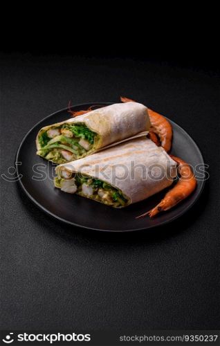 Delicious fresh roll with shrimps, tomatoes, lettuce and cucumber in pita bread on a dark concrete background. Delicious fresh roll with shrimps, tomatoes, lettuce and cucumber in pita bread