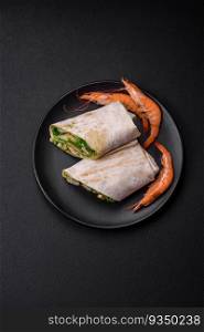 Delicious fresh roll with shrimps, tomatoes, lettuce and cucumber in pita bread on a dark concrete background. Delicious fresh roll with shrimps, tomatoes, lettuce and cucumber in pita bread