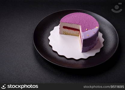 Delicious fresh sweet mousse cake with berry filling topped with pink velvet topping on dark concrete background