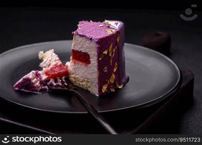 Delicious fresh sweet mousse cake with berry filling topped with pink velvet topping on dark concrete background