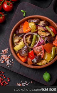 Delicious fresh vegetarian salad with tomatoes, green beans, eggplant, pepper, salt, spices and herbs on a dark concrete background. Delicious fresh vegetarian salad with tomatoes, green beans, eggplant and pepper