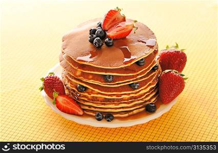 Delicious freshly prepared pancakes with strawberry and blueberries