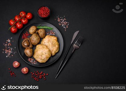 Delicious fried chopped fillet pancakes with spices, salt and herbs on a dark concrete background