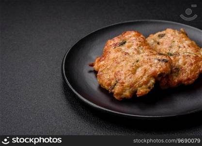 Delicious friedχcken chop or pork meat fried breaded with sa<, sπces and herbs on a dark concrete background
