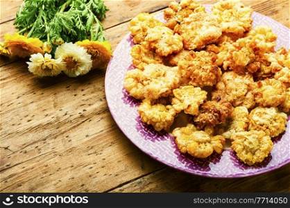 Delicious fried edible flowers. Chrysanthemum flowers in batter.Vegan food. Chrysanthemum flowers roasted in batter