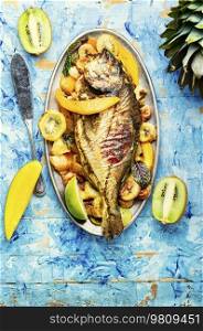 Delicious fried fish carp with fruits. Seafood. Fried fish in fruit.