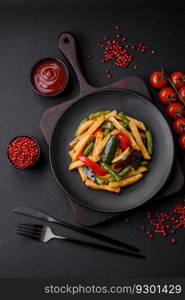 Delicious fried potatoes with bell peppers, asparagus beans, salt and spices in a plate on a dark concrete background