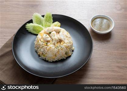 Delicious Fried rice with crab meat, egg, garlic, cucumber, lemon. Thai food called Khao pad poo.