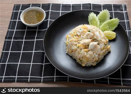 Delicious Fried rice with crab meat, egg, garlic, cucumber, lemon. Thai food called Khao pad poo.