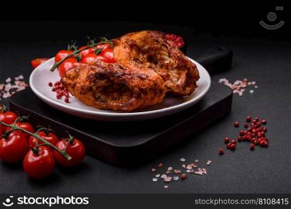 Delicious fried sea bass fish in the form of slices with spices and herbs on a ceramic plate on a dark concrete background