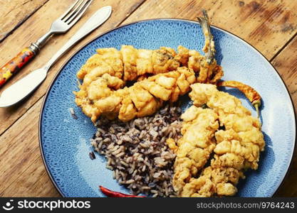 Delicious fried sea bass with rice garnish.. Deep fried sea bass with rice.