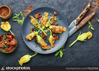 Delicious fried zucchini flowers stuffed with sun-dried tomatoes.Summer food.. Fried zucchini flowers with filling.