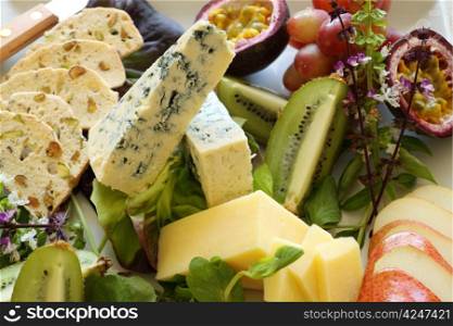 Delicious fruit and cheese platter featuring a variety of different cheeses and fresh fruits.