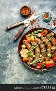 Delicious german sausages with grilled mushrooms and tomatoes. Tasty grilled sausages