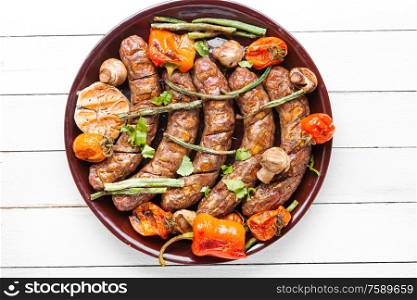 Delicious german sausages with grilled mushrooms and tomatoes. Tasty grilled sausages