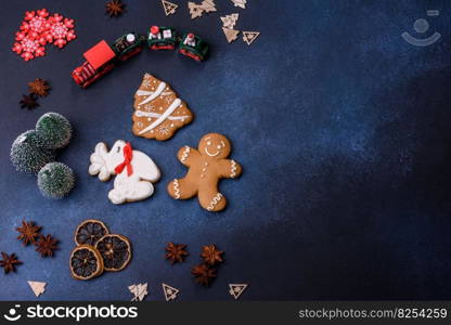 Delicious gingerbread cookies with honey, ginger and cinnamon. Winter composition. Elements of Christmas decorations, sweets and gingerbread on a wooden cutting board