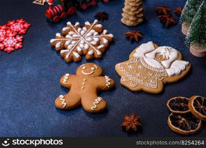 Delicious gingerbread cookies with honey, ginger and cinnamon. Winter composition. Elements of Christmas decorations, sweets and gingerbread on a wooden cutting board