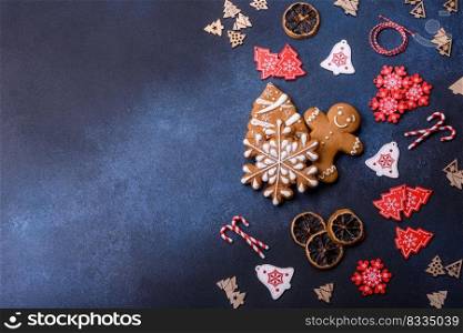 Delicious gingerbread cookies with honey, ginger and cinnamon. Winter composition. Christmas homemade gingerbread cookies on a dark concrete table