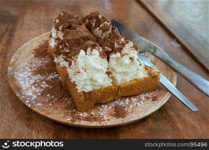 Delicious golden french toast and whipped cream. Extreme shallow depth of field. with cocoa powder home made