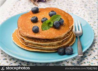 Delicious golden pancakes with fresh blackberries.