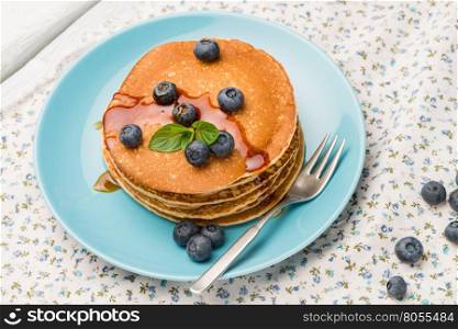 Delicious golden pancakes with fresh blackberries.