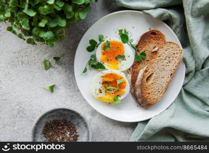 Delicious gourmet Breakfast. Rye bread  with boiled egg,  freshly ground pepper and microgreens. Healthy food. 