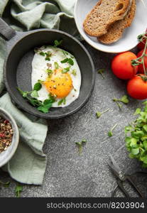 Delicious gourmet Breakfast. Rye bread  with fried egg,  freshly ground pepper and salad with redish and microgreens. Healthy food. 