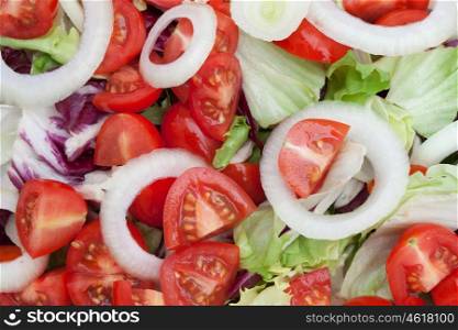 Delicious green salad with tomatoes and onion rings