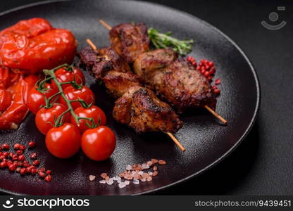 Delicious grilled chicken, turkey or pork skewers with salt, spices and herbs on a fire on a dark concrete background