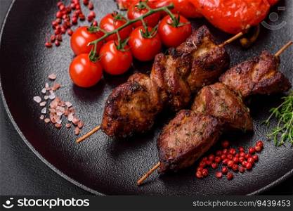 Delicious grilled chicken, turkey or pork skewers with salt, spices and herbs on a fire on a dark concrete background