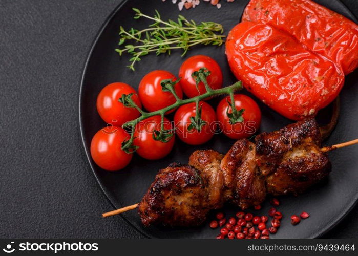 Delicious grilled chicken, turkey or pork skewers with salt, spices and herbs on a fire on a dark concrete background