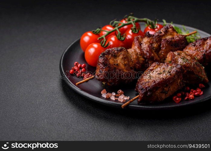 Delicious grilled chicken, turkey or pork skewers with salt, spices and herbs on a fire on a dark concrete background